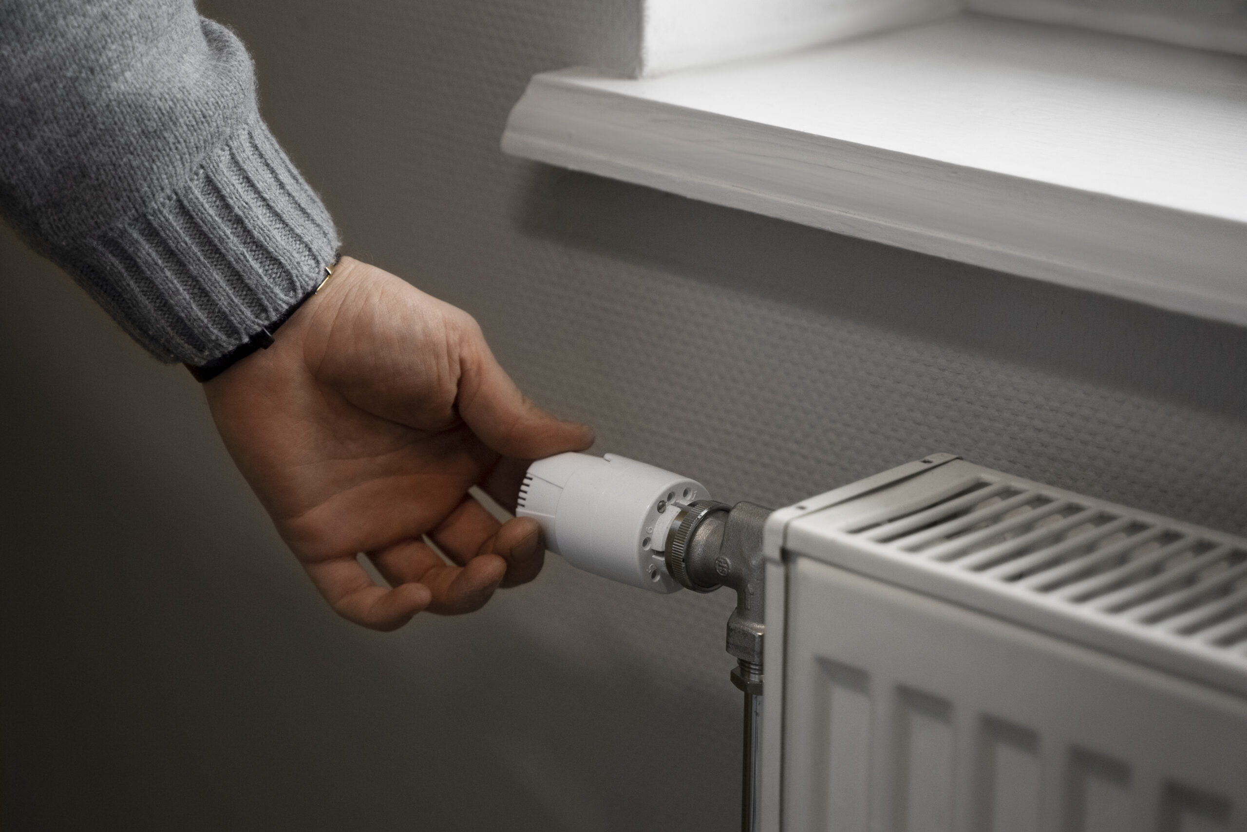 man-turning-off-radiator-during-energy-crisis
